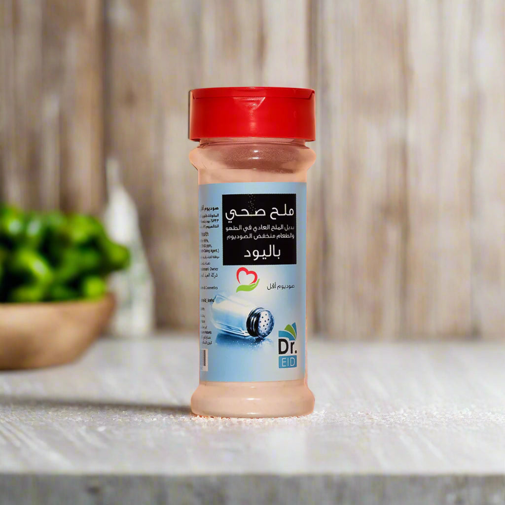 A bottle of Dr. Eid Himalayan Healthy Salt with a red cap, labeled in Arabic and English, indicating the product is a 250g container.